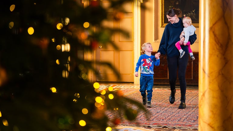 A family exploring Wimpole Hall at Christmas